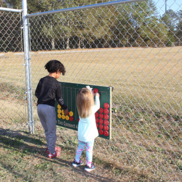 Green Connect 4 Panel Mounted on a Fence